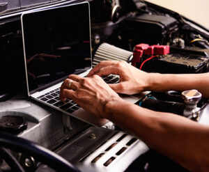 Professional car repair or maintenance mechanic engine working
